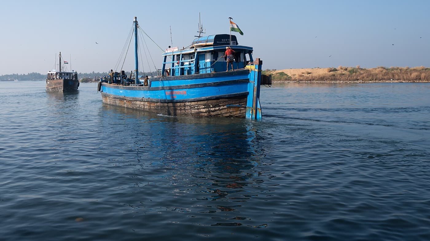 A blue fishing trawler on the water off Mangaluru